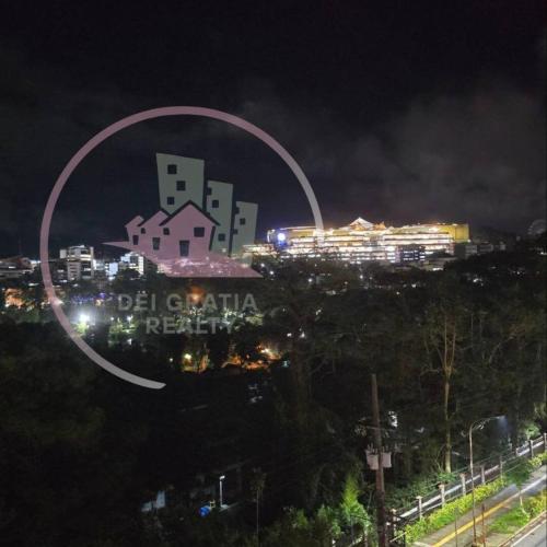 a view of a city at night with a circle at Burnham 411 Baguio Condo Transient by Dei Gratia in Baguio