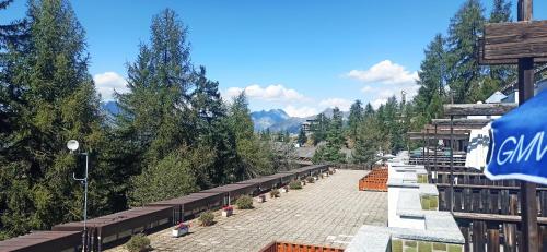 a street with benches and trees on a mountain at Dal Buffo Gufo in Pila