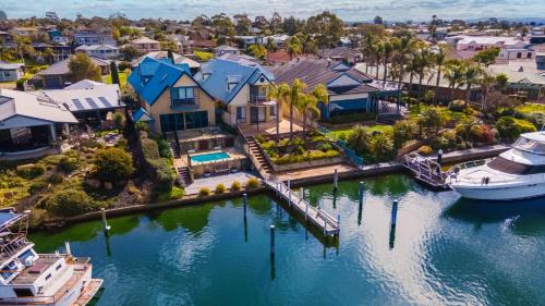 an aerial view of a house with a boat in the water at The Loft in Paynesville