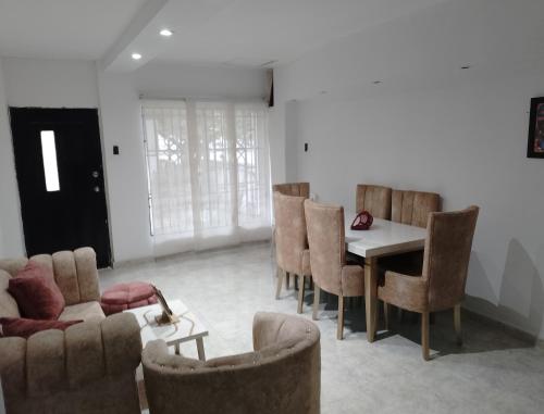 a living room with a table and chairs at Alto prado 75 house in Barranquilla