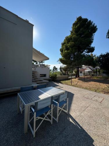 a picnic table in front of a house at Akti elia apartment in Kalogria