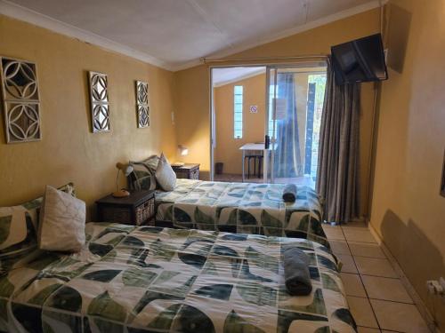 Ένα ή περισσότερα κρεβάτια σε δωμάτιο στο At Home Guesthouse