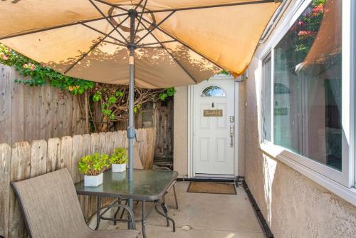 a table with an umbrella on a patio at Relax Explore from Mission Viejo Pool Spa in Mission Viejo