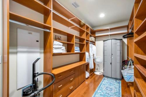 a dressing room with wooden shelves and a closet at Relax Explore from Mission Viejo Pool Spa in Mission Viejo