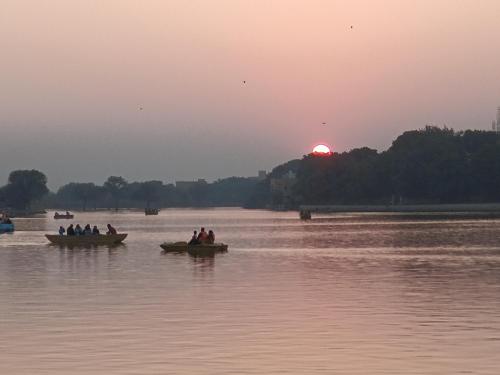 a group of people in boats on a river at sunset at Welcome Jaisalmer Camp in Jaisalmer