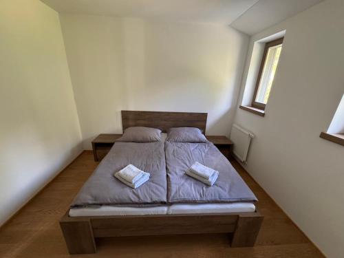 a bedroom with a bed with two pillows on it at Restaurace Přístav Kostkov in Návsí u Jablunkova