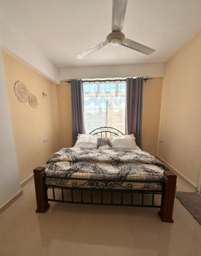 Ένα ή περισσότερα κρεβάτια σε δωμάτιο στο Swahili Serenity Homes