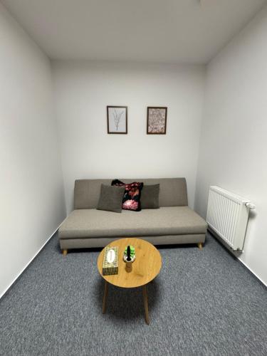 a living room with a couch and a table at Restaurace Přístav Kostkov in Návsí u Jablunkova
