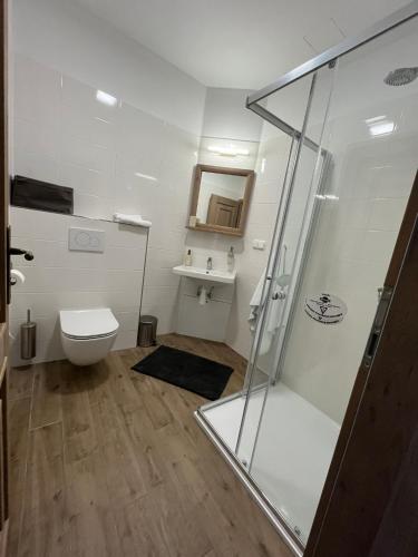 a bathroom with a shower and a toilet at Restaurace Přístav Kostkov in Návsí u Jablunkova