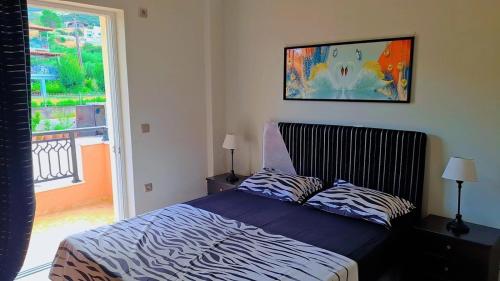 a bedroom with a zebra print bed with a window at Roe Sea View in Kyparissia