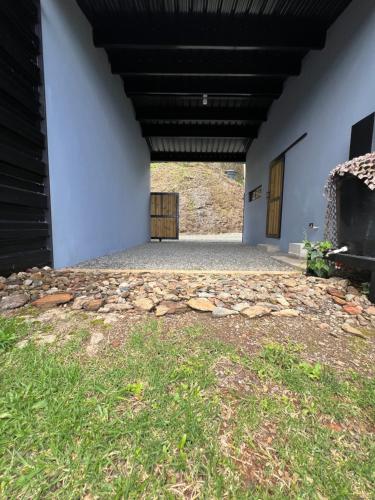a building with a stone floor and a building with a door at Cabañas DALI la catedral in Envigado