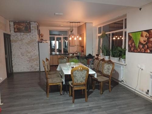 a kitchen and dining room with a table and chairs at Guest House StarSky in Karakol