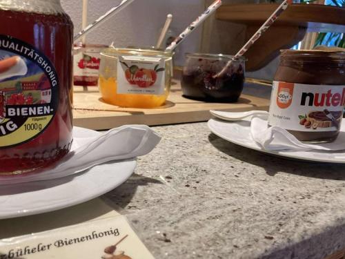 a counter with jars of jam and plates of food at Hotel Metzgerwirt in Kirchberg in Tirol