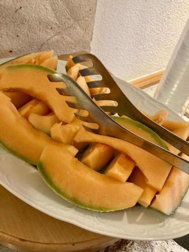 a plate of food with a fork and a sandwich at Hotel Metzgerwirt in Kirchberg in Tirol