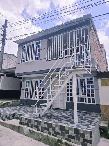 a house with a white staircase on the front of it at Villa Liliana in Armenia