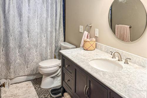 a bathroom with a sink and a toilet and a mirror at Hummingbird Hideaway in Tucson