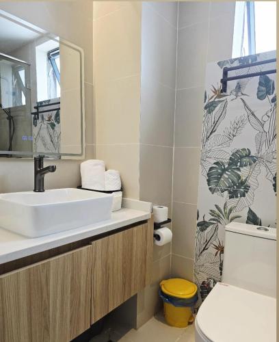 a bathroom with a sink and a toilet and a mirror at Reily Luxury Homes - Studio Apartment, Syokimau near JKIA & SGR, PARK VIEW in Nairobi