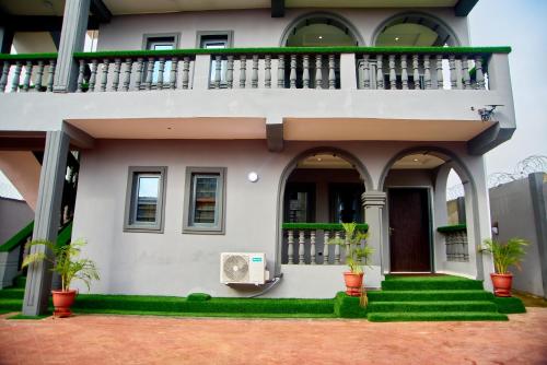 a house with a balcony and plants in front of it at THE NEST by CHECKLIST in Pakuro