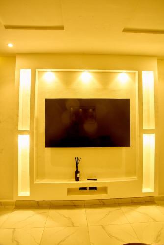 a large flat screen tv in a living room at THE NEST by CHECKLIST in Pakuro