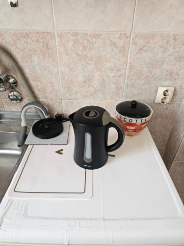 a black coffee mug sitting on top of a kitchen counter at Apartment K8 Center in Podgorica