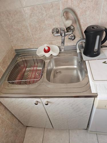 a kitchen counter with a sink and a sink at Apartment K8 Center in Podgorica