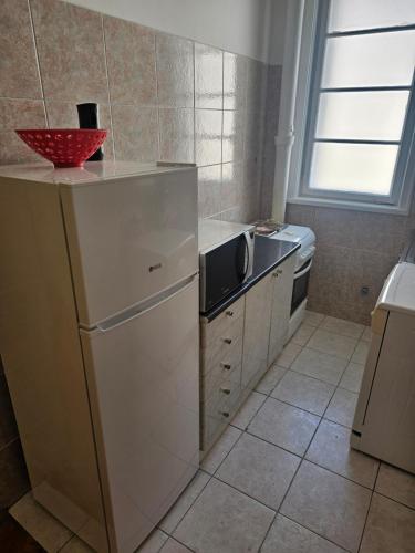 a kitchen with a sink and a microwave at Apartment K8 Center in Podgorica