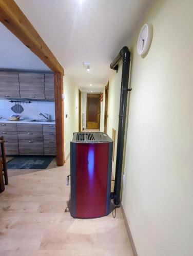 a room with a heater in the corner of a room at Appartamento Alta Valle Maira 