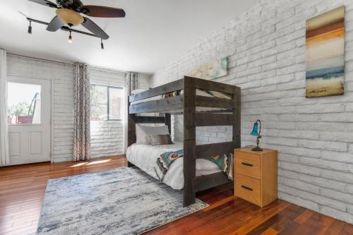 a bedroom with a bunk bed and a brick wall at Pony Soldier Sedona Escape in Sedona
