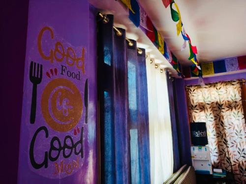 a restaurant with a sign on the wall with a fork and spoon at Adhyan homestay kalpa in Kalpa