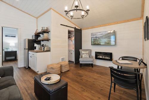 a living room with a couch and a table and a fireplace at Hidden Gem in Hungry Horse in Hungry Horse