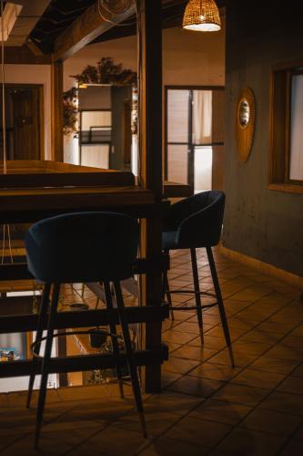 two chairs sitting at a table next to a pool table at THIS IS COLOMBIA HOSTEL in San Gil