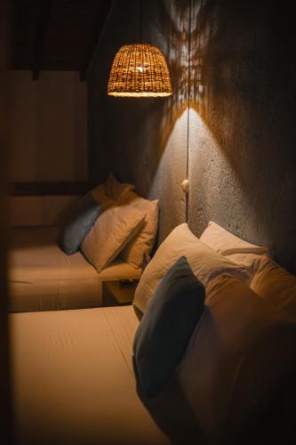 a bedroom with two beds and a lamp and a wall at THIS IS COLOMBIA HOSTEL in San Gil