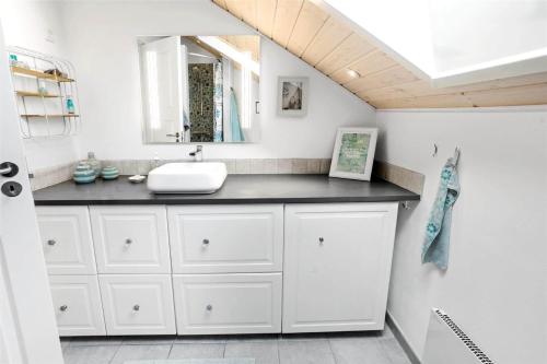 a bathroom with a sink and a mirror at L18-Rodby-Vibevej-9 in Rødby