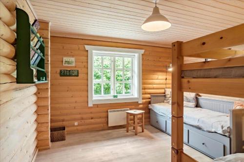 a room with two beds in a log cabin at M130-Vaeggerlose-Marielyst-Strandpark-125 in Marielyst