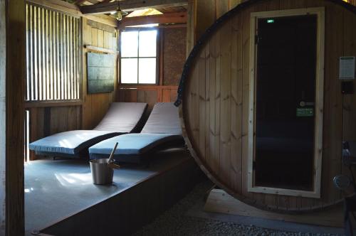 two beds sitting in a room with a barrel at SAUNA&CURRY URI Kyotango - Vacation STAY 31580v in Kyotango