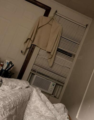 a bedroom with a bed and a window with blinds at Franklin street allston in Boston