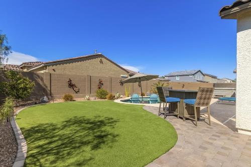 a backyard with a lawn with a table and chairs at Golden Marigold Sanctuary in Buckeye