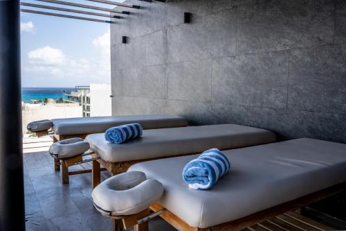 a room with four beds and a view of the beach at Luxury Penthouse with Ocean Views and Private Pool in Playa del Carmen