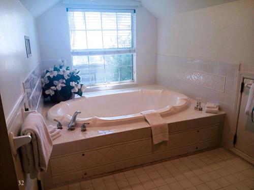 a large bath tub in a bathroom with a window at The Cozy Inn in Saint Augustine
