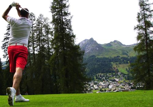 a man swinging a golf club on a hill at Aarau West Swiss Quality Hotel in Oberentfelden