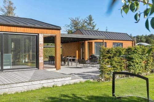 a house with a deck and a patio at M350-Vaeggerlose-Grapilevej-2-A in Marielyst