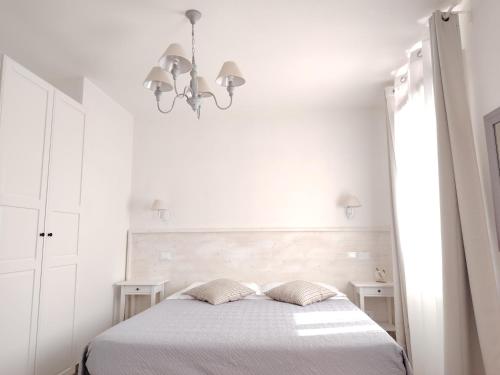 a white bedroom with a bed with two pillows at Agriturismo Honey Farm in Piazzola sul Brenta