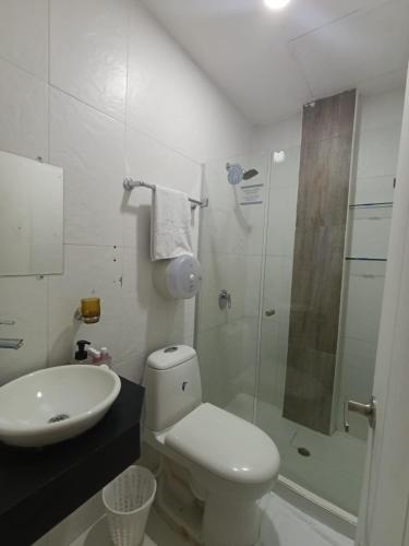 a bathroom with a toilet and a sink and a shower at Art Hotel Getsemani in Cartagena de Indias