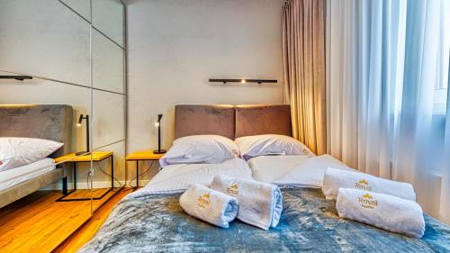 a bedroom with two beds with pillows on it at Apartament Loft- IzerSKI Resort in Świeradów-Zdrój