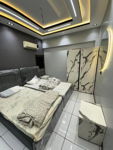 two beds in a room with a ceiling at Double Delight-Two Single Beds, Private Entrance Available On Sharing Also in Karachi