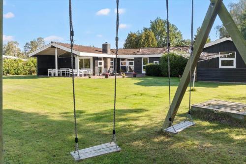 a swing set in the yard of a house at M346-Vaeggerlose-Skovlystvej-42 in Marielyst