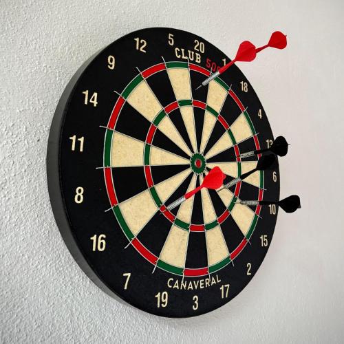 a dart board on a wall at Coorg Robusta Retreat in Suntikoppa