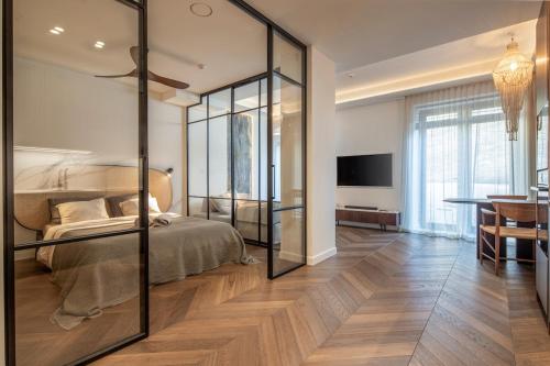 a bedroom with a bed with a glass wall at Golden Dunes & SPA in Nida