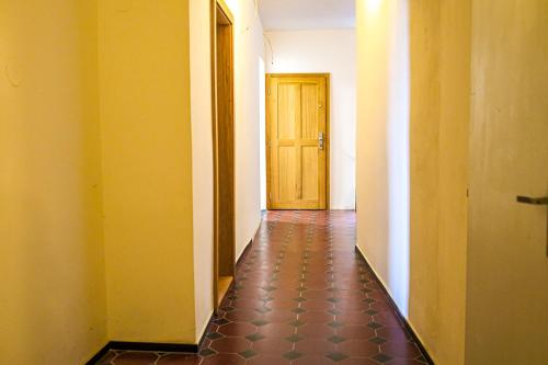 an empty hallway with a door and a tile floor at Luxury Apartments Pivovarské domy in Hradec Králové