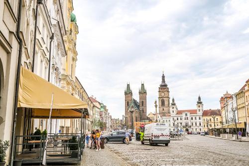 a city street with buildings and a clock tower at Luxury Apartments Pivovarské domy in Hradec Králové